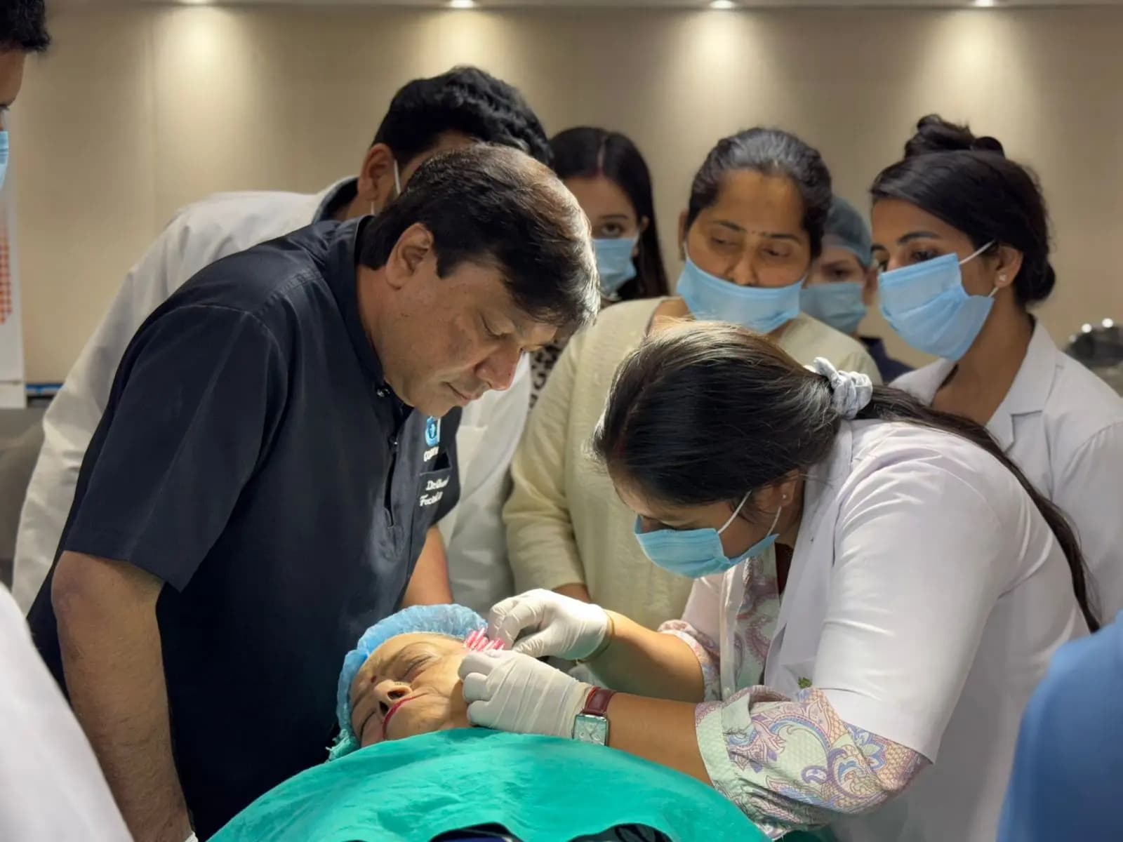 Trainees watching a supervised procedure on a patient