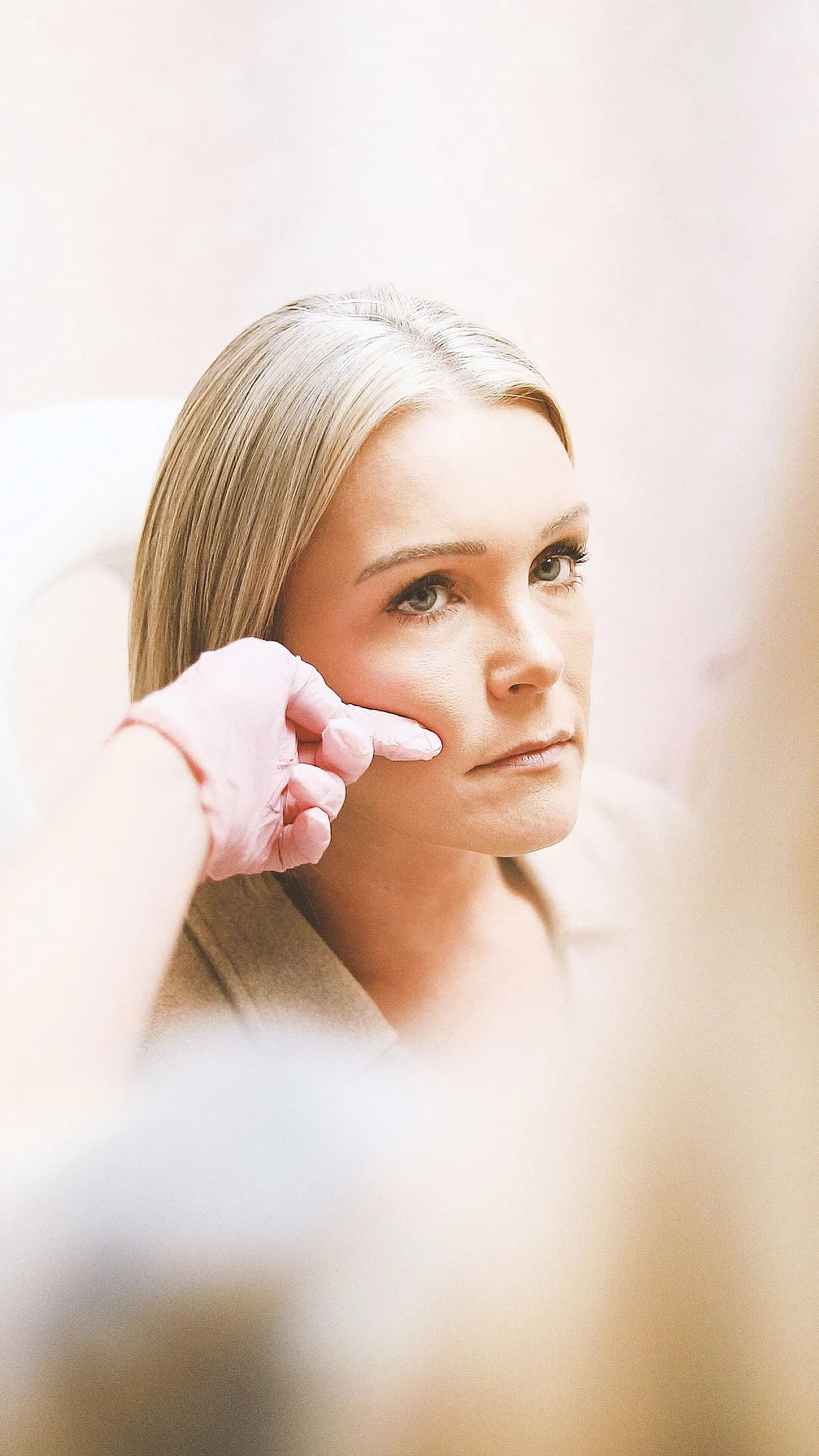 Specialist assessing the skin of the cheek
